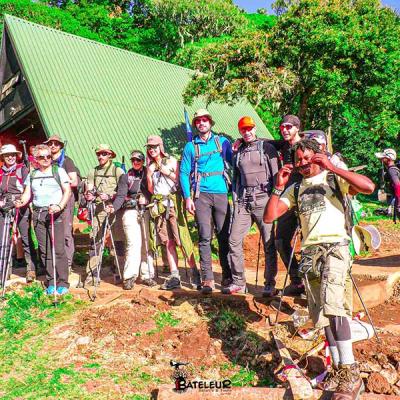 Bateleur Safari In Kilimanjaro National Park Trekking Mountain Kilimanjaro With Our Guests A Few Meter Ahead To The Top
